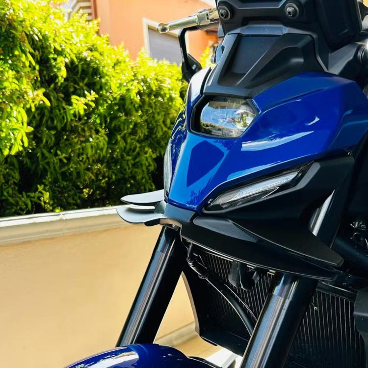 Motorcycle front spoiler downforce winglets, black installed on blue motorcycle