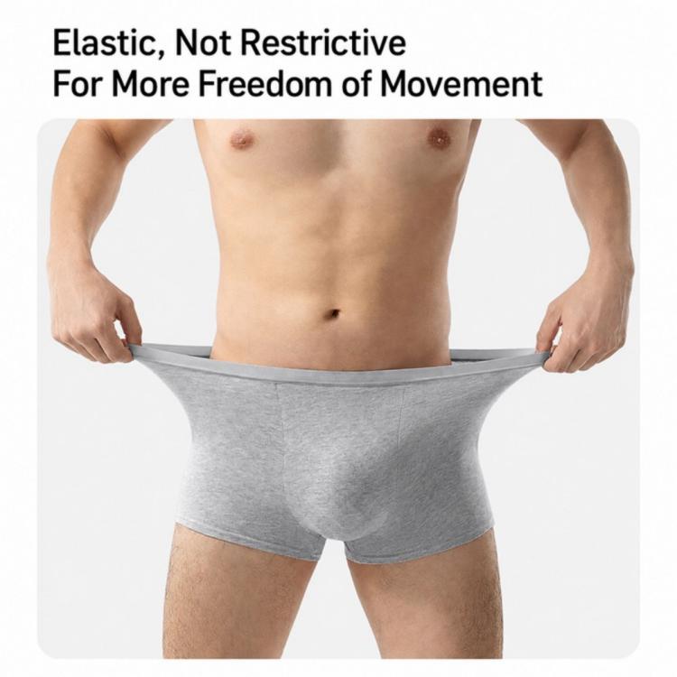 Men's grey disposable boxer briefs on model, elastic waistband and roomy stretch fit.
