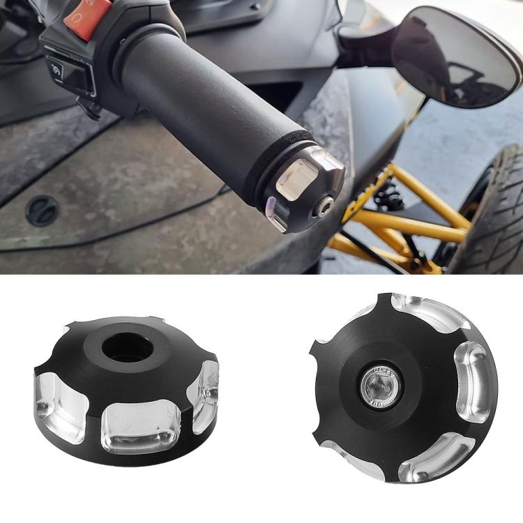 Motorcycle handlebar end cap in black with silver end section, mounted on bar