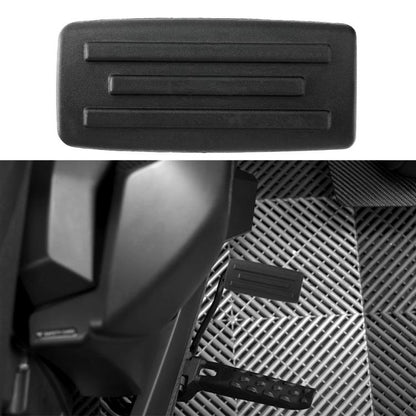 Extended brake foot rest pedal, black rubber with ridged grip and rectangular shape.