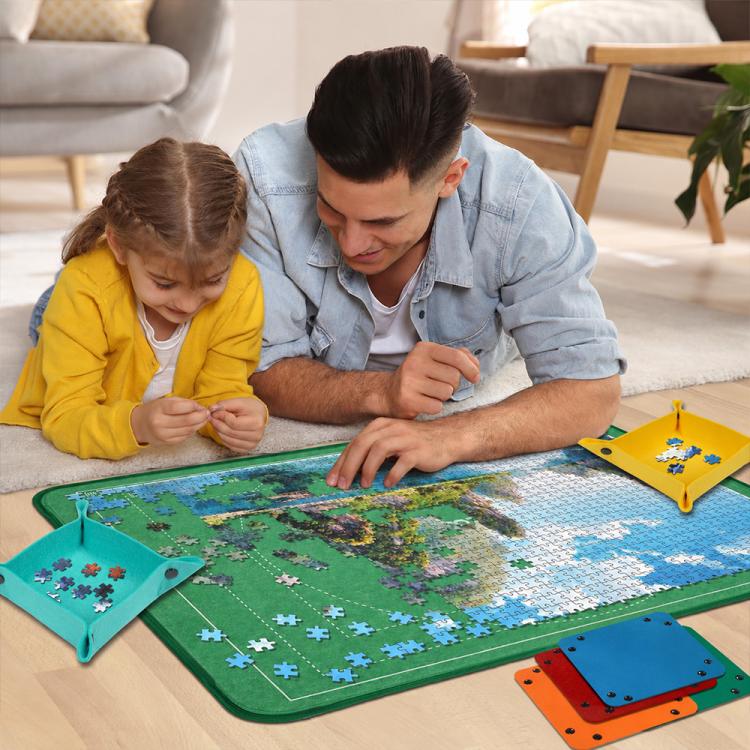 Kids using a foldable puzzle mat with sorting trays, green mat on the floor