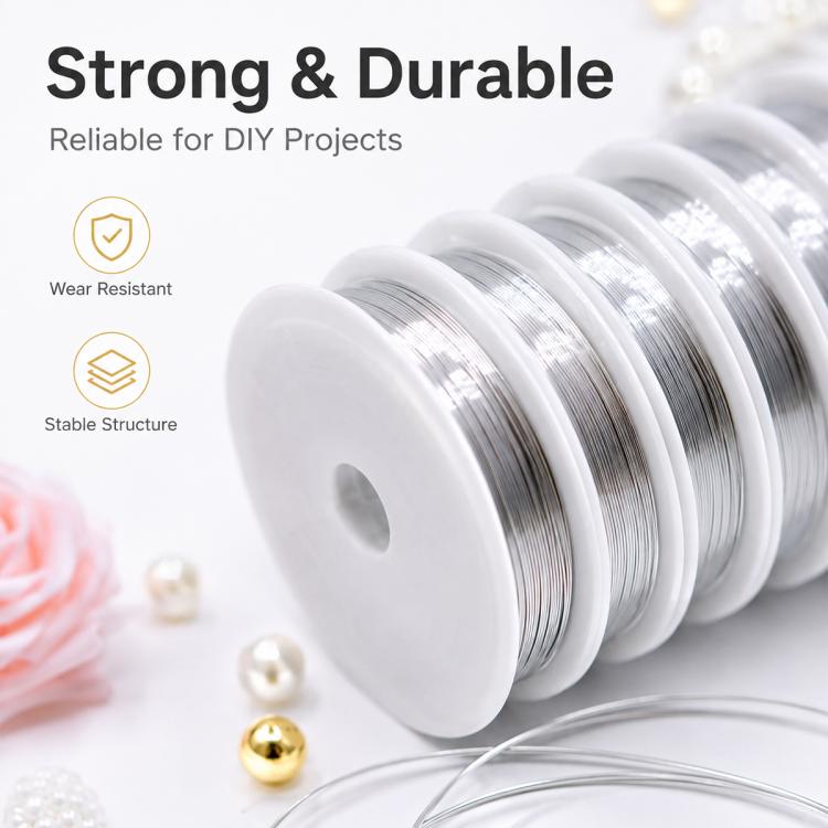 Close-up of metallic silver beading wire coils on stacked white plastic spools