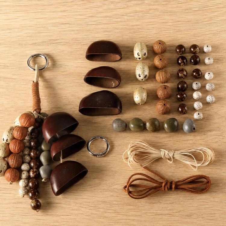 Natural seed bead set with mixed shells and beads, brown and cream cords, and metal ring