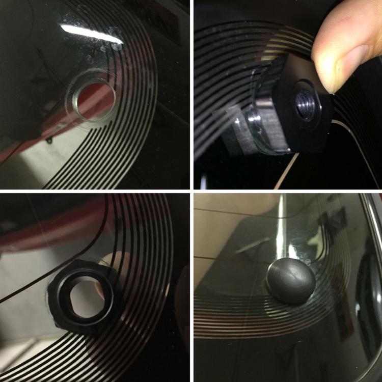 Rear window glass strut seal installation close-up with black mounting hardware