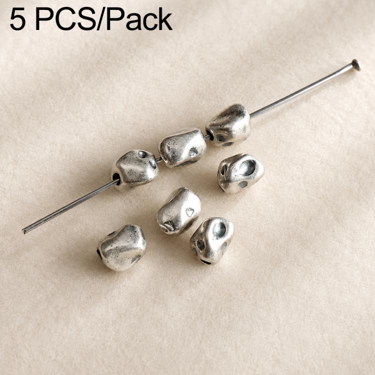 Assorted small dark silver beads with loop holes on a pin, textured rounded shapes