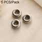 Three round dark silver spacer beads with central loop openings, textured outer rim