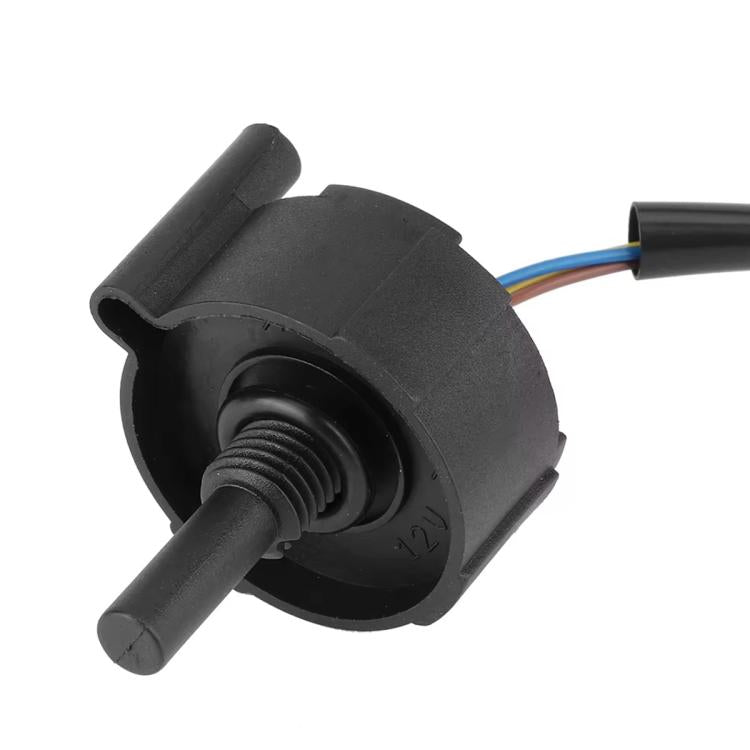 Fuel water sensor close-up: black housing with threaded outlet and wire leads