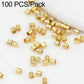 Gold-tone crimp end beads, close-up pile of small metal tube separator clips