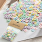 Colorful resin flower buttons in a clear pack, pastel multicolor 12mm pieces