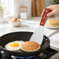Stainless steel round spatula with wooden handle, flipping breakfast pancakes in a pan