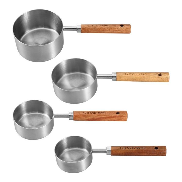 Stainless steel measuring cup spoon set with wooden handles, four cup sizes shown