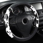 Cow print steering wheel cover in black and white, wrapping wheel grips and spokes