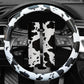 Cow print steering wheel cover with black-and-white pattern over the wheel rim