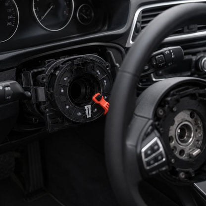 Steering wheel clock spring airbag cable assembly with orange release tab, shown opened