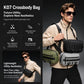 Black crossbody bag with green stripe accents, worn crossbody with adjustable strap.