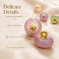 Close-up of pink resin disc buttons with gold shanks and loops, glossy finish