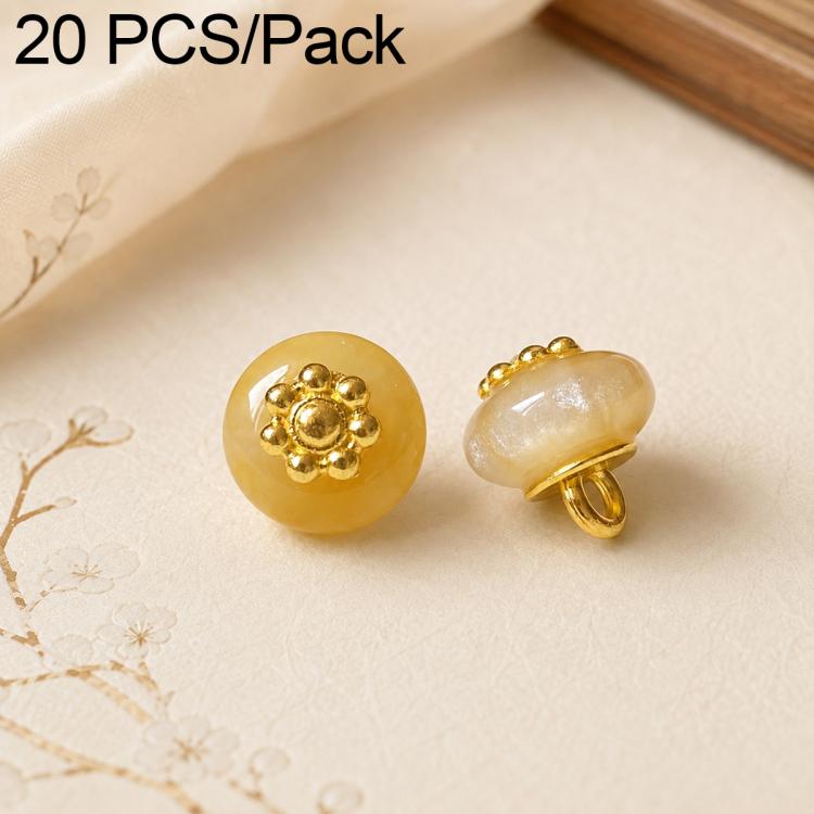 Light yellow resin flat flower-shank buttons with gold decorative flower tops, 2 shown