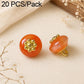 Orange-red resin flat flower-shank buttons with gold decorative flower tops, 2 shown