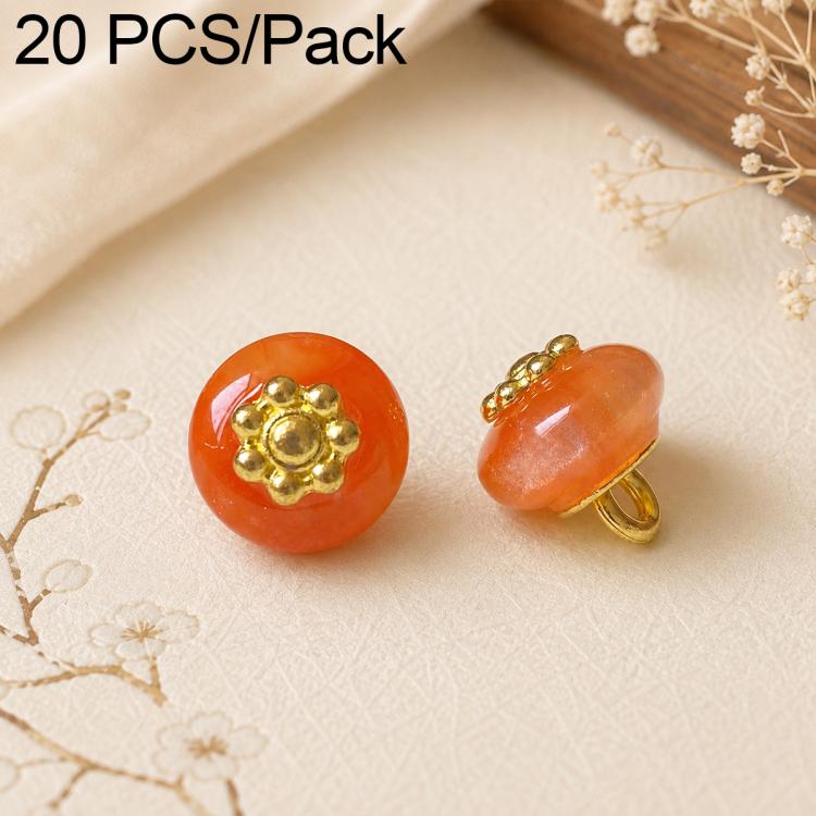 Orange-red resin flat flower-shank buttons with gold decorative flower tops, 2 shown