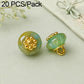 Mint green resin floral shank button with gold flower top and gold loop shank