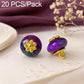 Dark purple resin floral shank button with gold flower top and gold loop shank