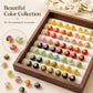 Assorted gold-flecked resin flower shank buttons displayed in a wooden tray