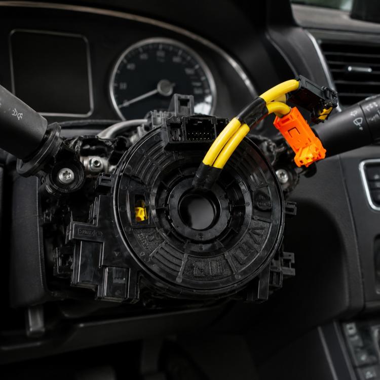 Steering wheel clock spring spiral cable with black housing, yellow leads, orange connector