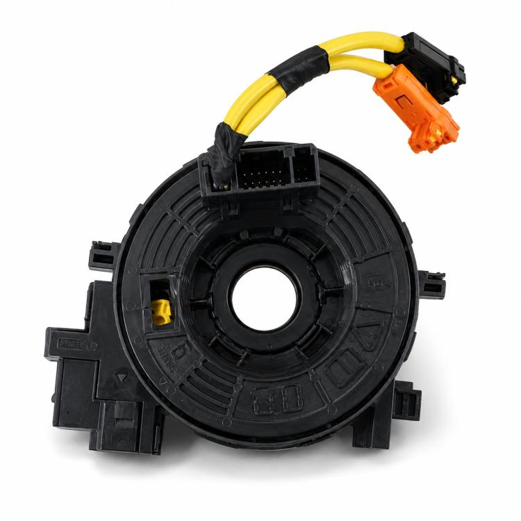 Steering wheel clock spring assembly, black circular housing with yellow cable and orange plug