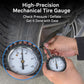 Car tire pressure gauge with brass-style dial, attached to a tire valve