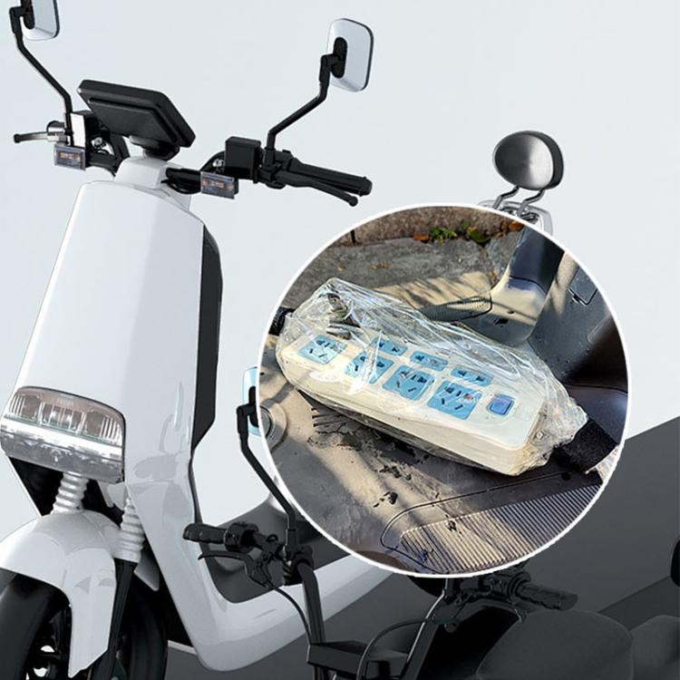 Transparent waterproof cover draped over outdoor power strip charger on vehicle handlebars
