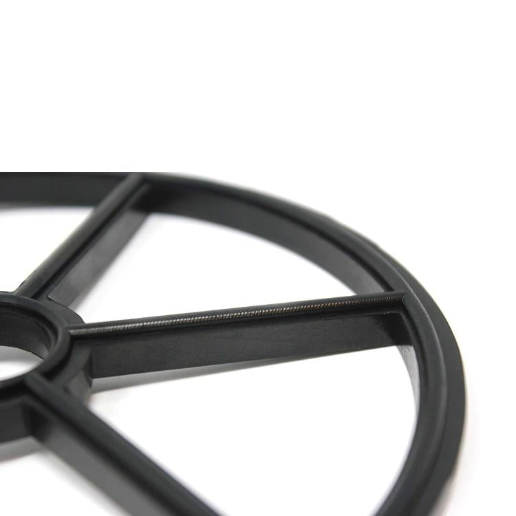 Close-up of black valve seat gasket spider arms and outer circular ring