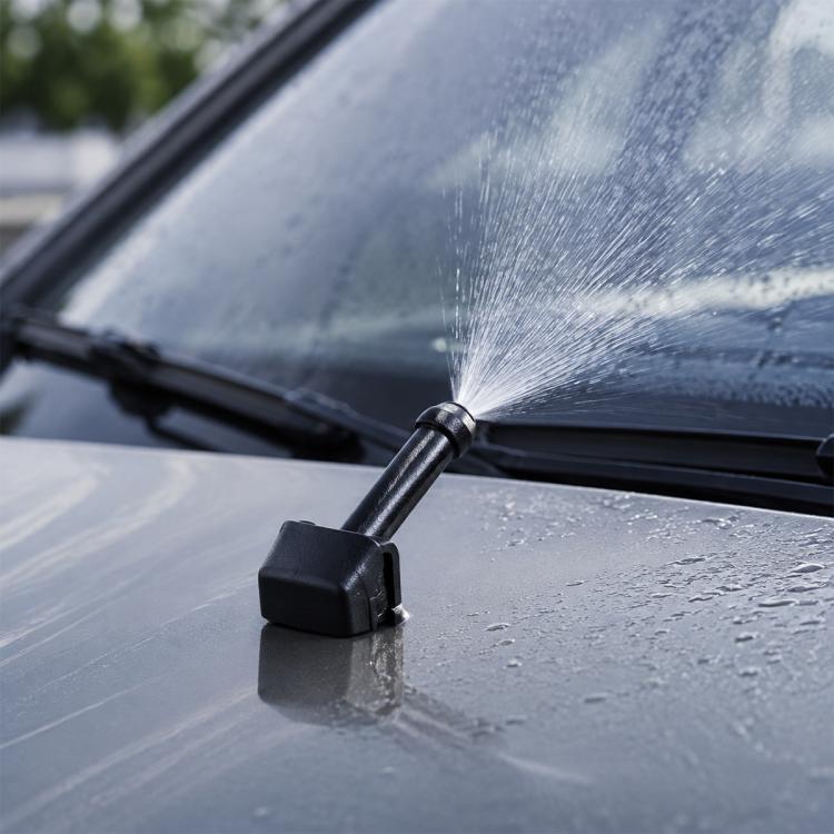 Car windshield washer wiper jet nozzle with water spray from the front window