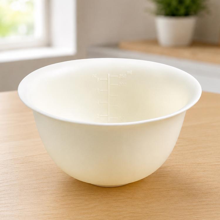 Cream soft silicone mixing bowl with clear oz and ml measurement markings