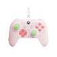 Translucent pink wired gaming controller with glowing green and red button accents