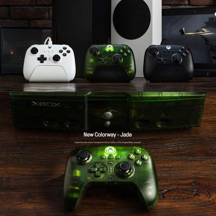 Green wireless game controller on tabletop with dual thumbsticks and face buttons