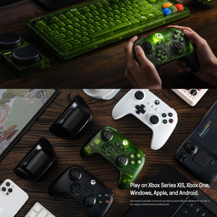 Green wireless game controller held in hand with dual thumbsticks and face buttons