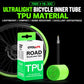CYCLAMi TPU road bicycle inner tube, green coil with valve beside wheel