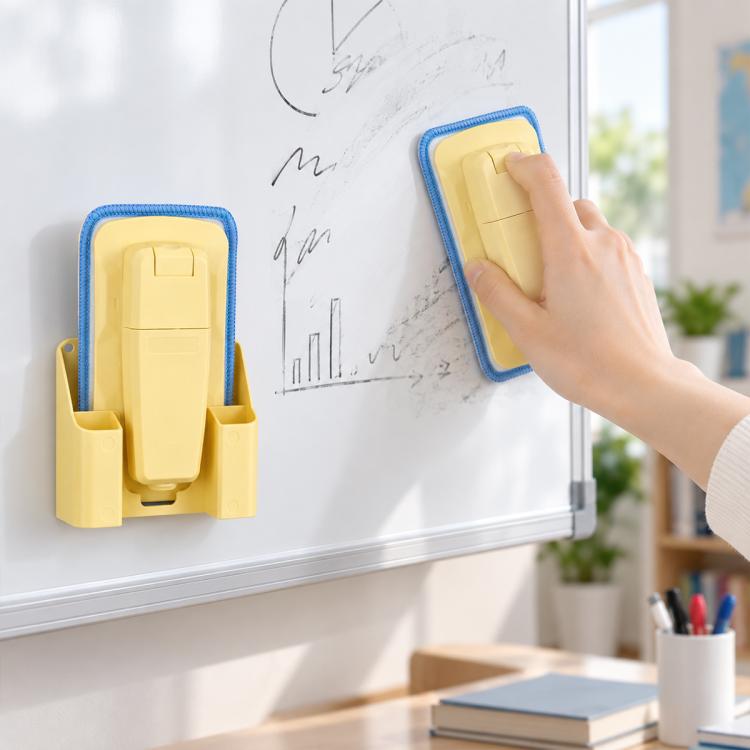 Yellow magnetic spray board eraser with detachable washable pad, held against whiteboard