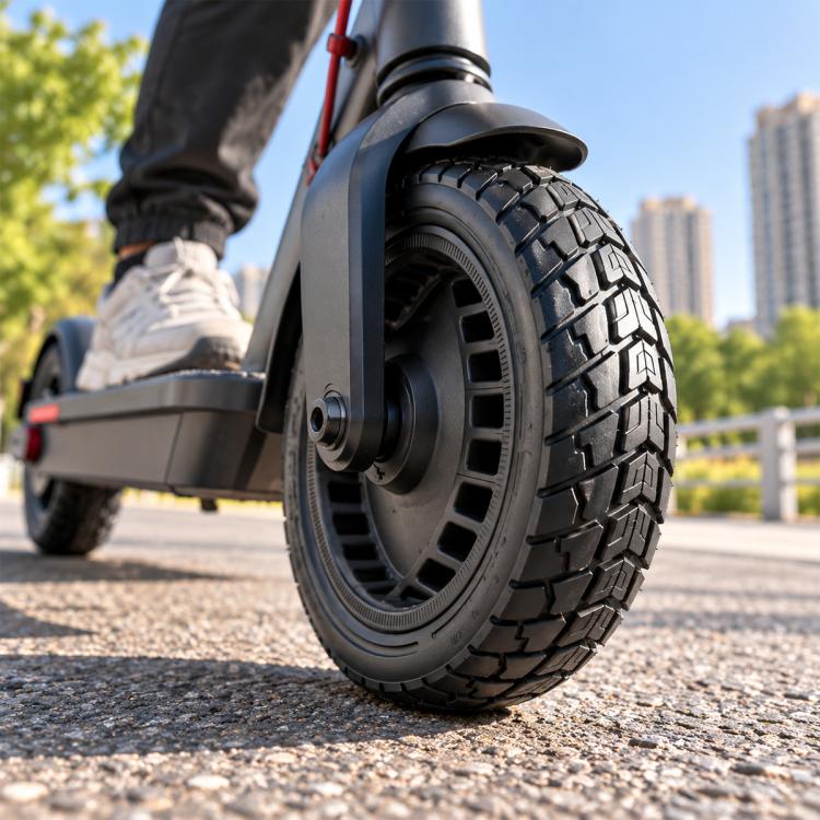 Black solid honeycomb scooter tire with deep tread, mounted on wheel.