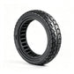Black solid honeycomb scooter tire, studio view showing sidewall and tread.