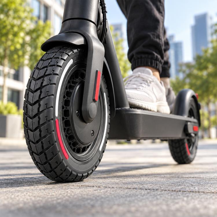 Solid scooter tire with black tread and red side stripe, close-up on wheel hub