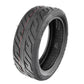 Black scooter tire with V-shaped tread and visible inner rim
