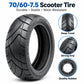 Black scooter tire with deep tread pattern and textured sidewall