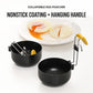Two black nonstick folding egg poachers with yellow silicone grip hanging handles
