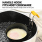 Black egg poacher hooked to a pot rim with yellow silicone-grip folding handle