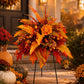 Orange-red fall floral garden stake arrangement with flower clusters, berries, and three stakes