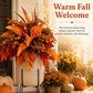 Fall floral garden stake arrangement in a tan planter with orange blooms and berry accents