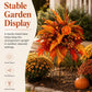 Orange-red fall floral garden stake arrangement with fern leaves, berries, and three stakes