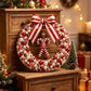 Red pearl Christmas wreath with red and white striped satin bow and beaded candy centerpiece