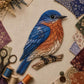 Layered patchwork blue-and-orange bird craft piece on fabric background